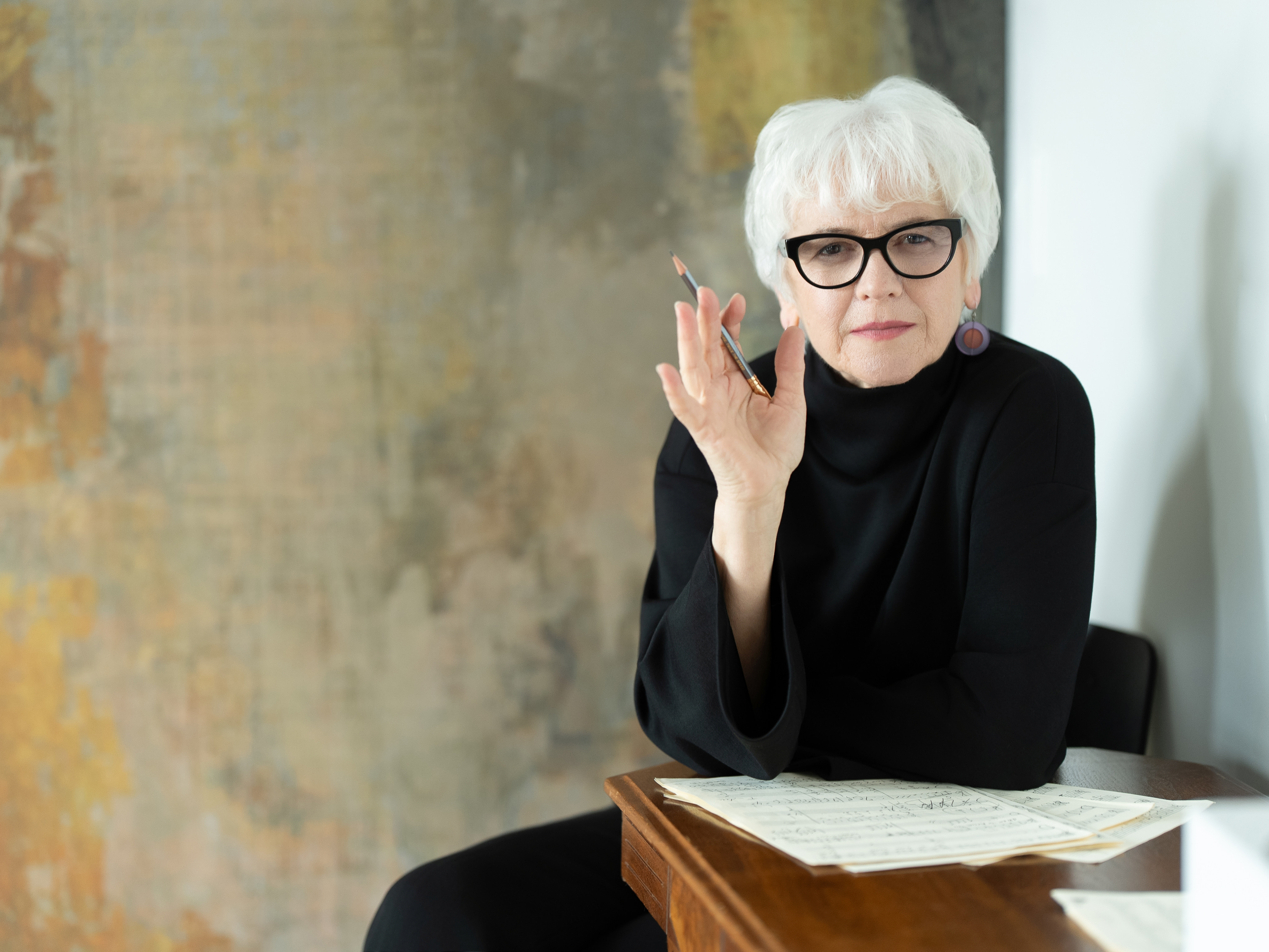 Portrait of Joan Szymko with her music scores